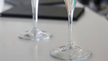 Two martini glasses with layered drinks on a bar counter.