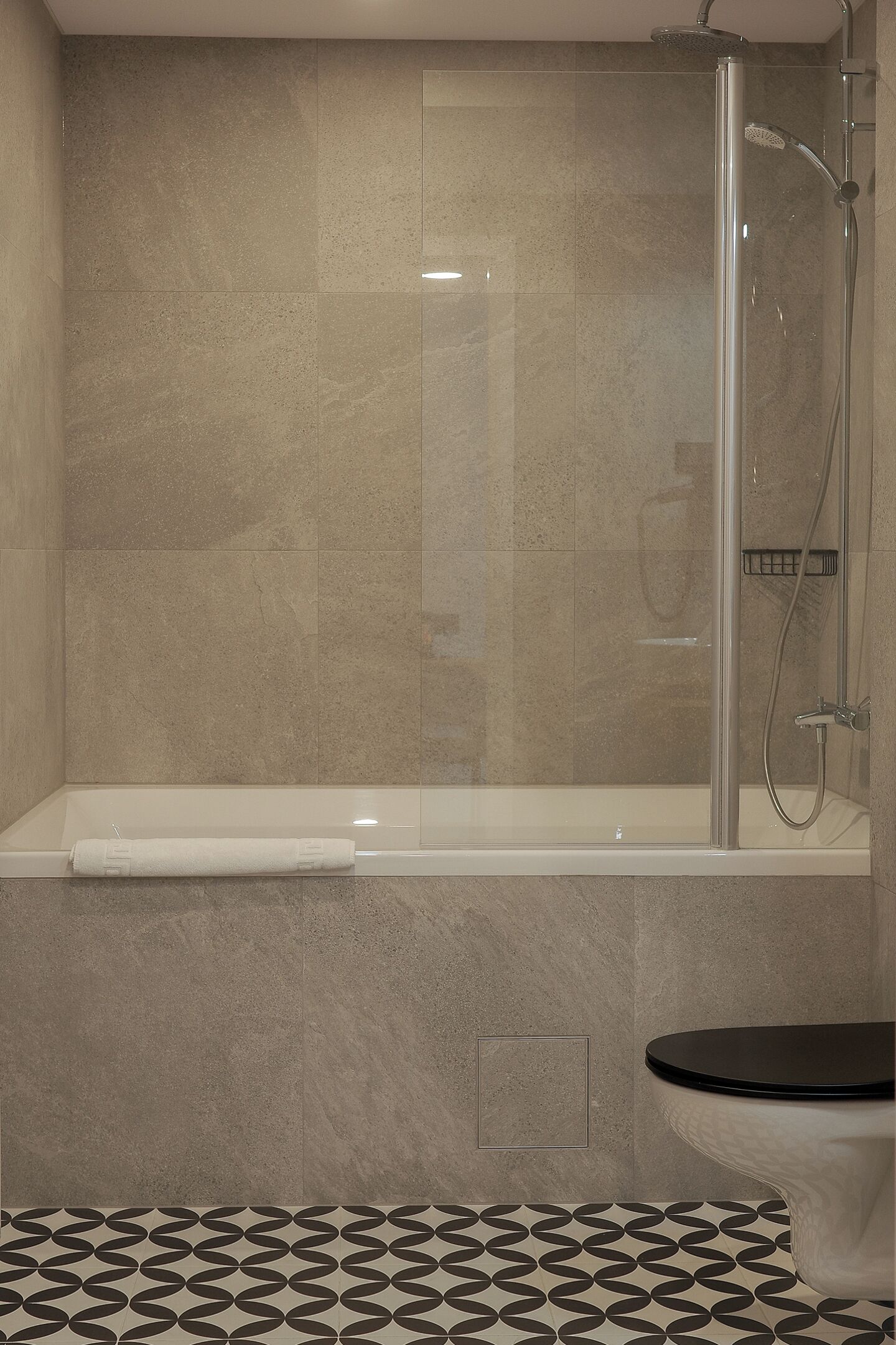 A bathroom with a shower enclosure, a bathtub, and a toilet.
