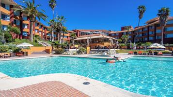 Alberca techada, alberca al aire libre y camastros