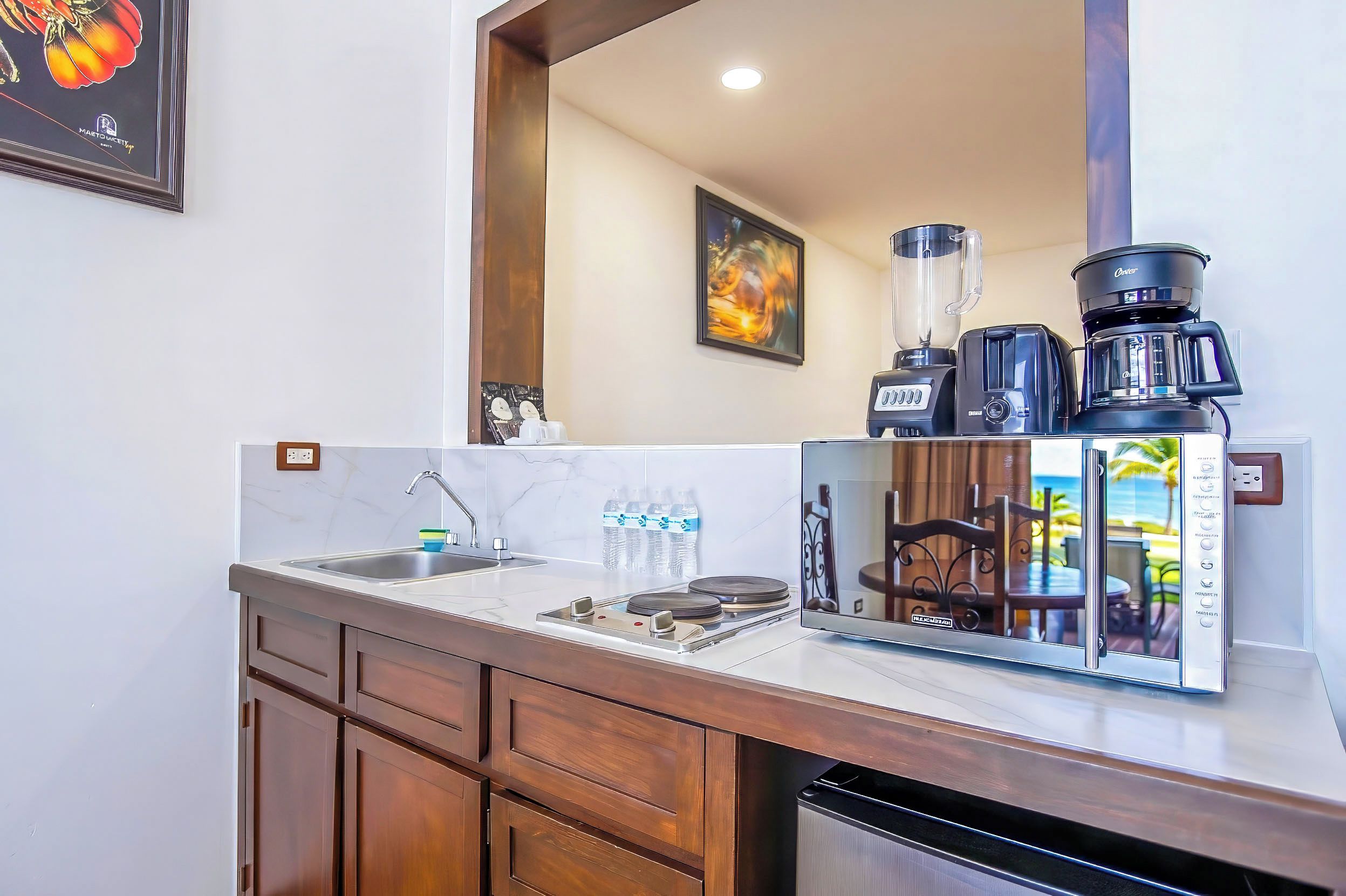 A modern kitchen with a built-in coffee maker, a blender, and a toaster.