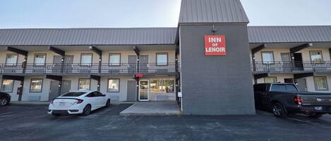 A motel with a sign reading 'Inn of Lenior' and a visible office entrance.