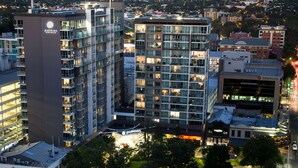 A hotel with multiple floors, balconies, and a prominent sign. - Pullman Adelaide (Adelaide)