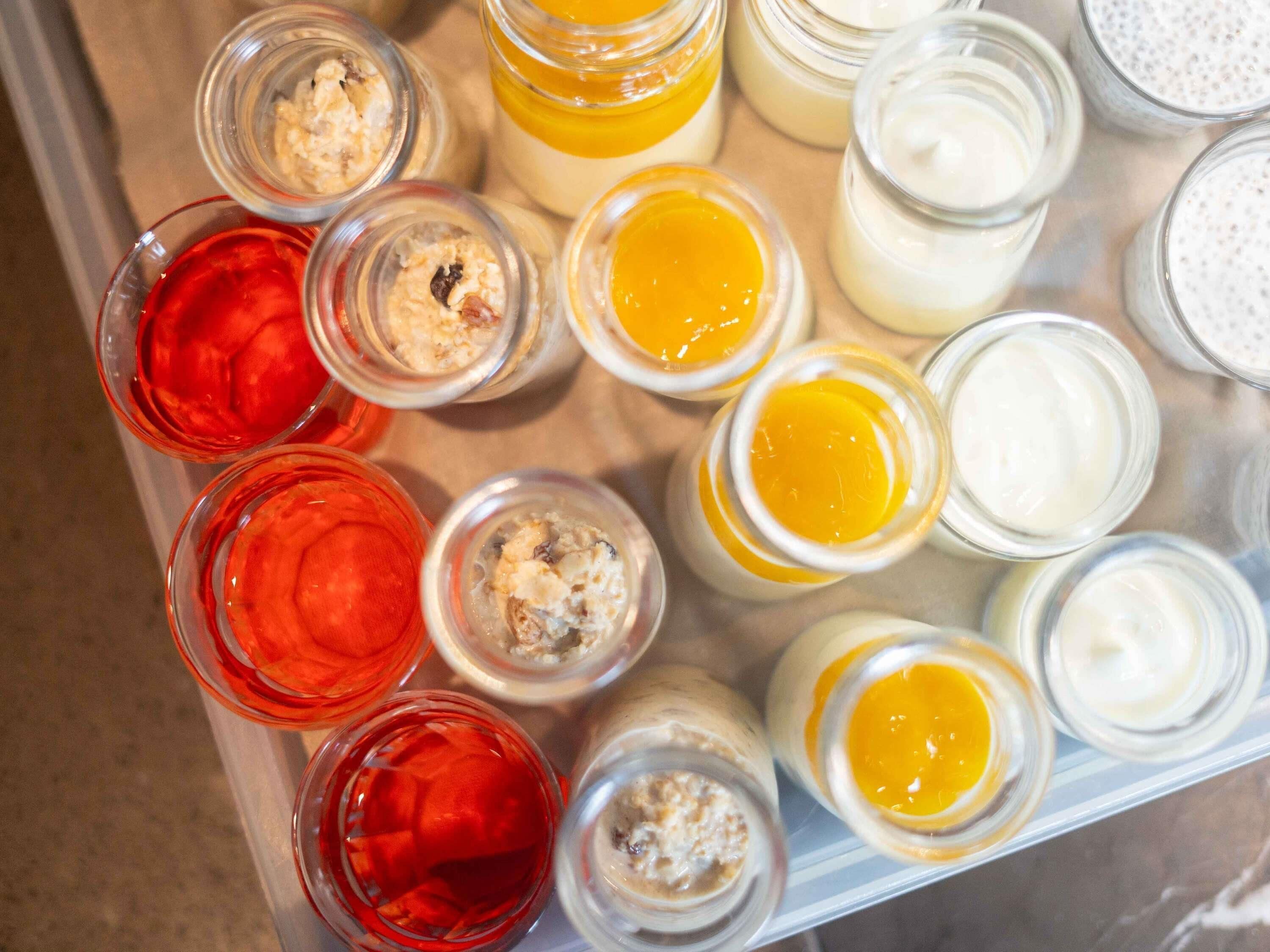A tray of various food items, including jars with different colored liquids and mixtures.