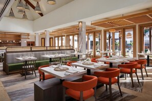 A modern restaurant with high ceilings, wooden beams, and a mix of booth and table seating. - Buccament BAY ALL Inclusive (Kingstown)