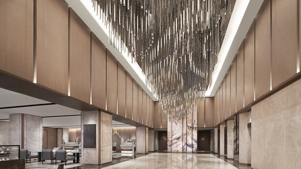 A spacious lobby with a high ceiling, marble flooring, and a modern chandelier. - Nanning Marriott Hotel (Nanning)