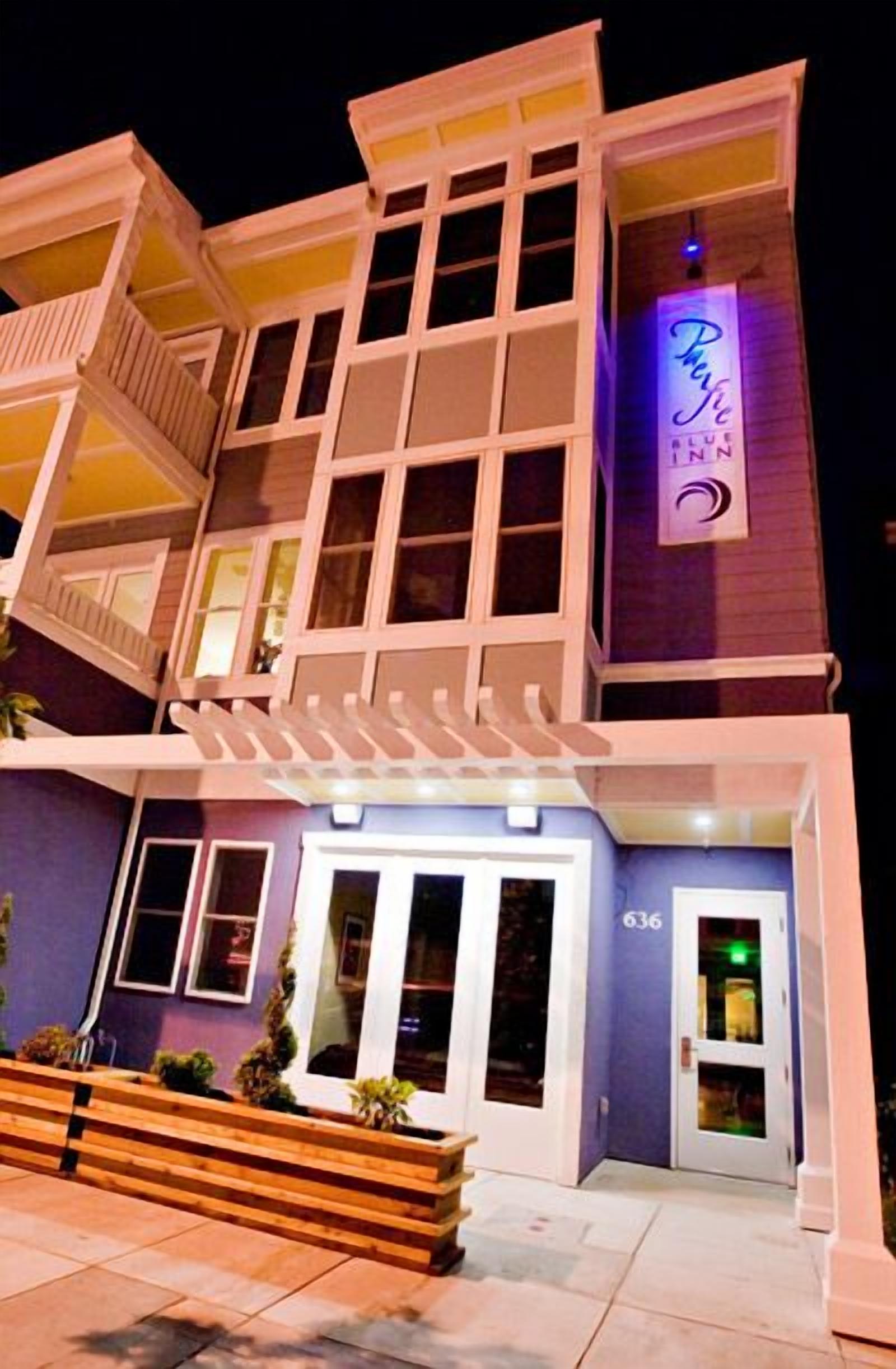 A multi-story hotel with a purple facade, a neon sign reading "Perry's Blue Moon," and a number "636" on the entrance.