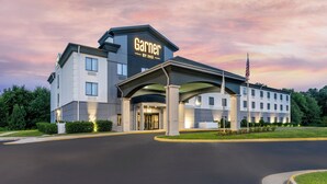 A hotel with a modern design, featuring a prominent entrance and a sign that reads "Garnier by IHG." - Garner Hotel Doswell Southeast by IHG (Doswell)