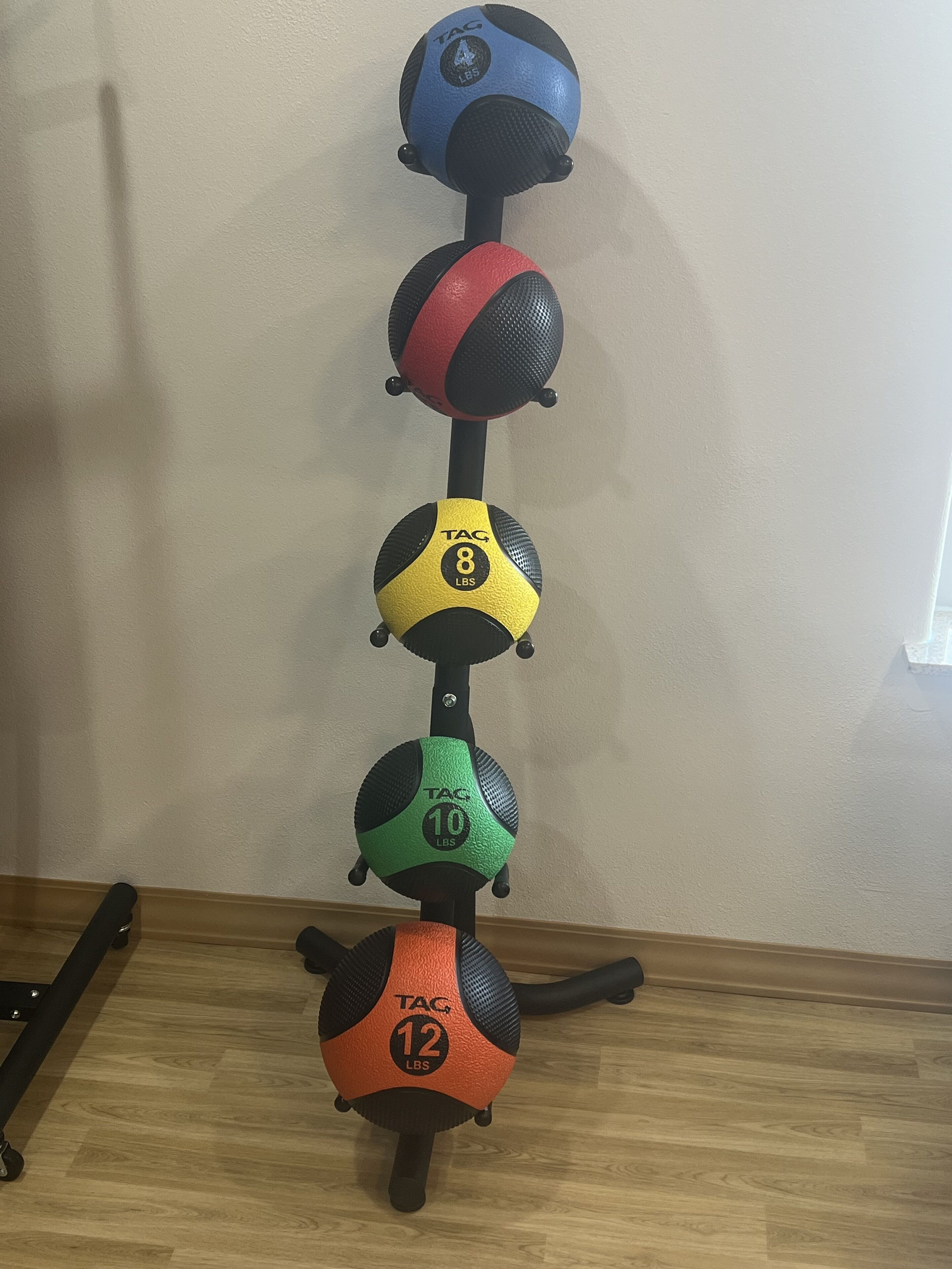 A set of exercise balls on a rack.