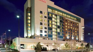 A Marriott hotel with multiple floors, large windows, and a well-lit facade. - Houston Marriott Energy Corridor (Houston)