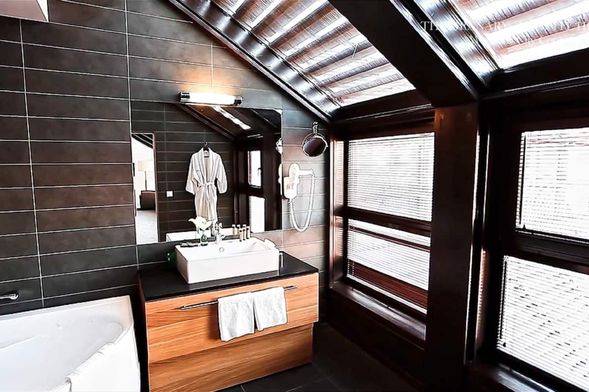 combined shower/bathtub, designer toiletries, hair dryer, bathrobes