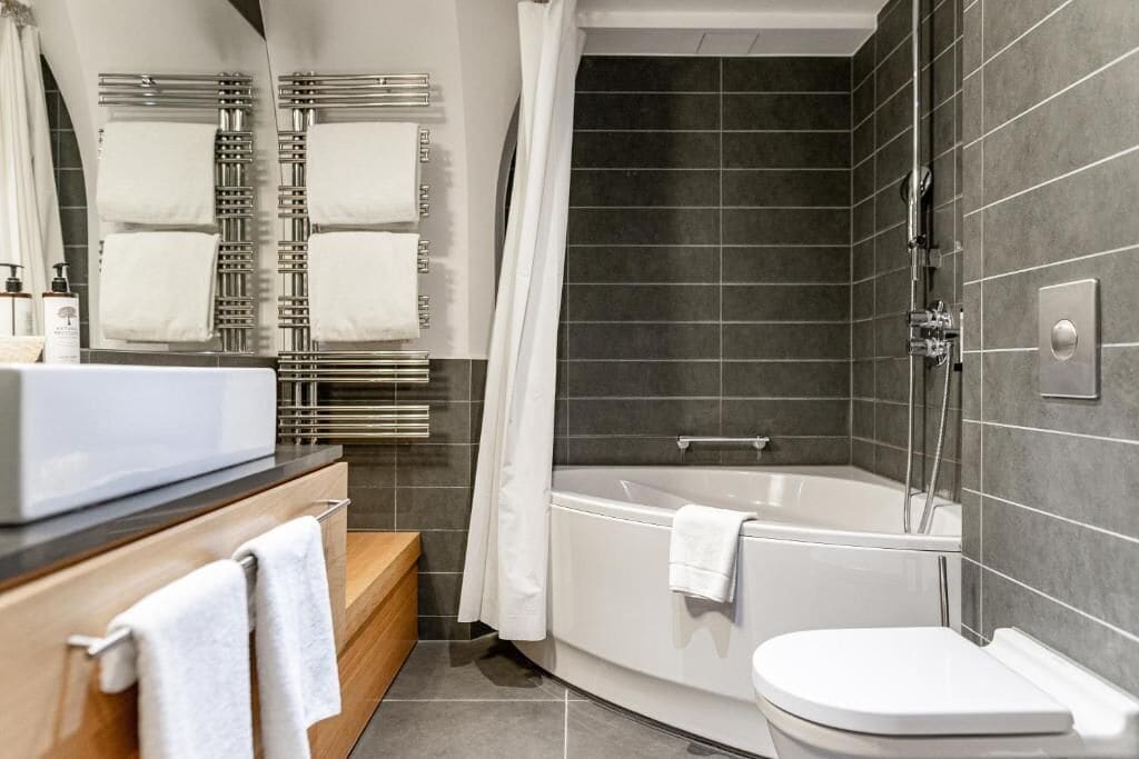 combined shower/bathtub, designer toiletries, hair dryer, bathrobes