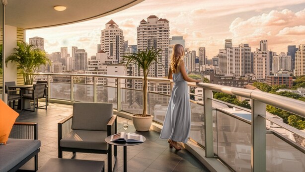 A modern rooftop terrace with a city skyline view, furnished with outdoor seating and a potted plant. - MUU Bangkok, Small Luxury Hotels of the World (Bangkok)
