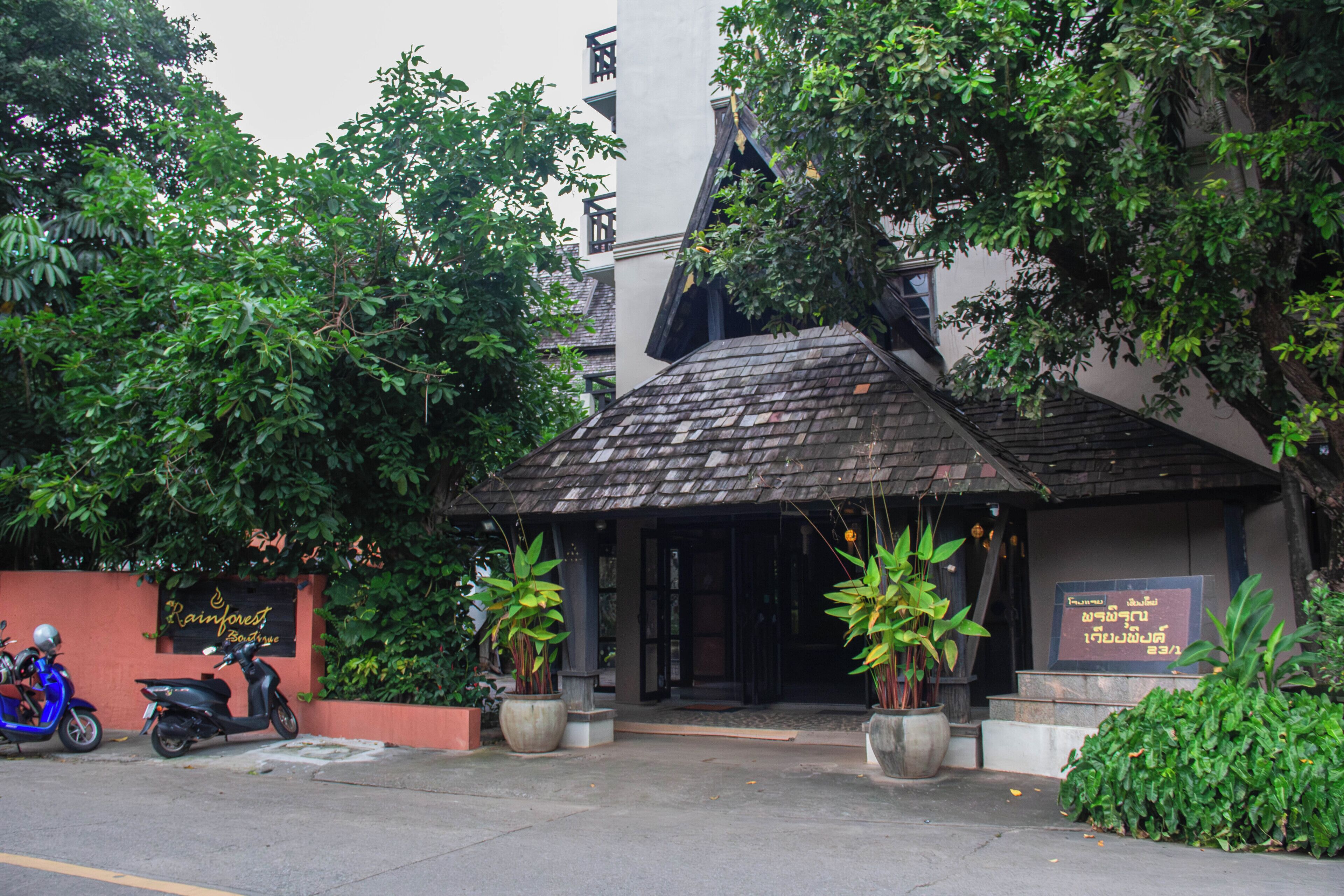 A building with a sloped roof and a signboard.