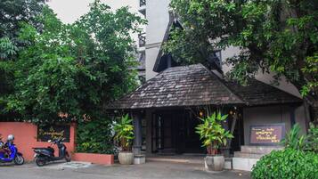 A building with a sloped roof and a signboard.