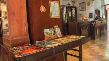 A reception desk with informational brochures and a framed certificate on the wall.