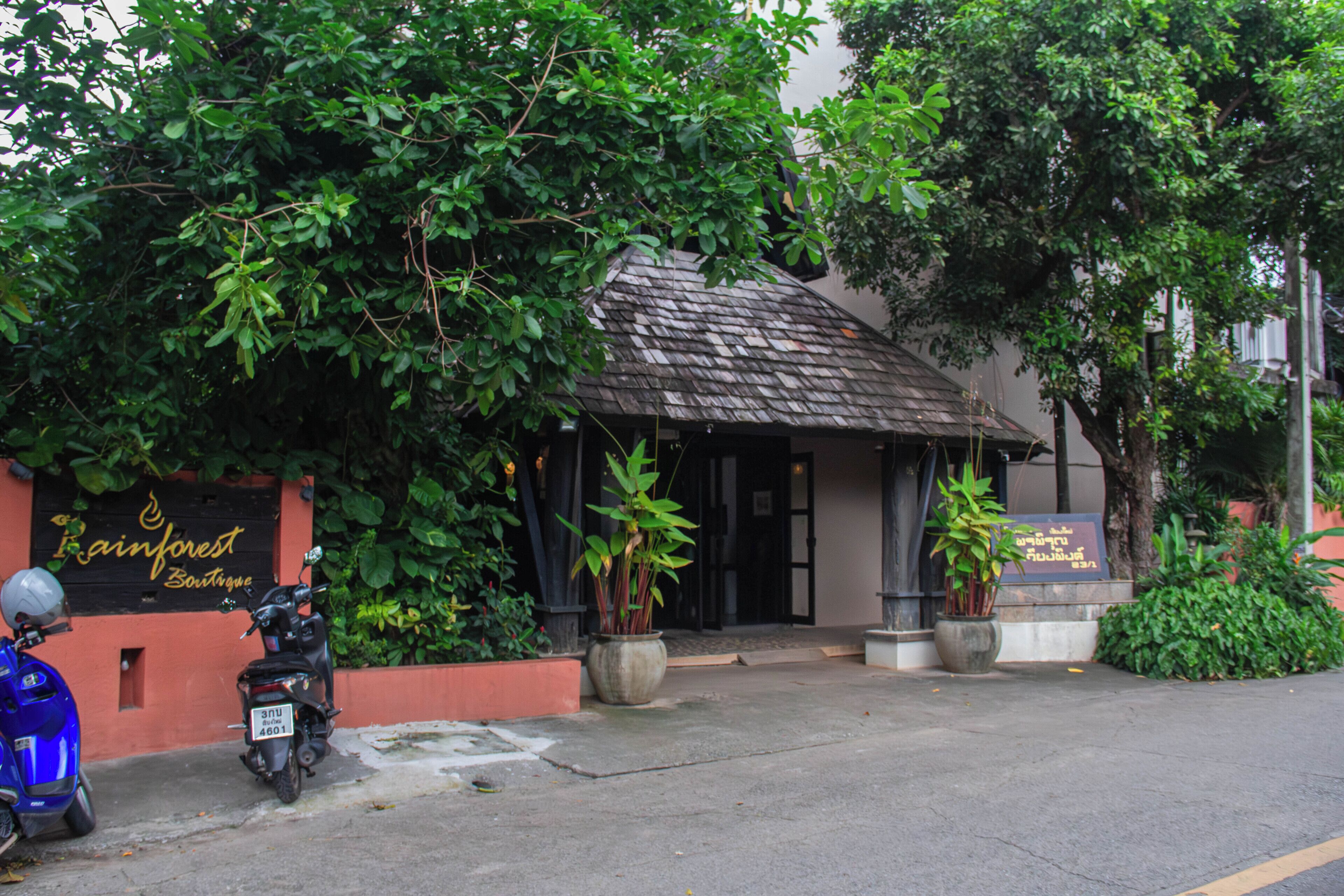 A building with a tiled roof and a signboard.