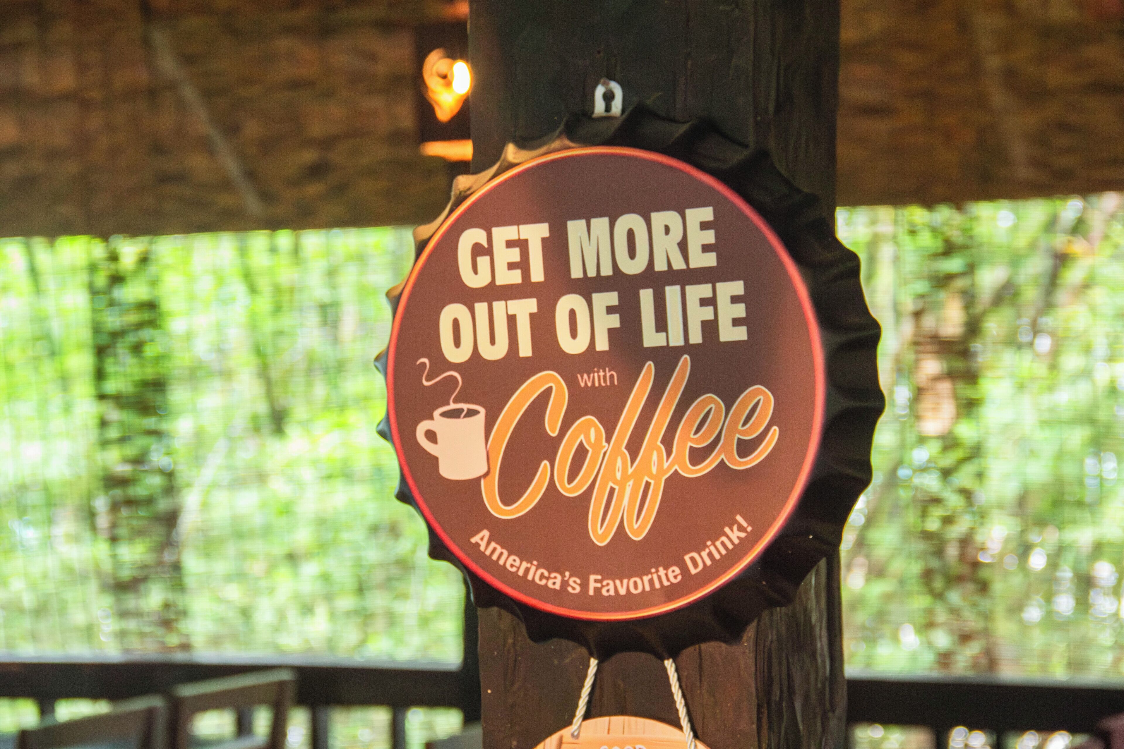 A sign with the text 'GET MORE OUT OF LIFE with Coffee. America's Favorite Drink.'