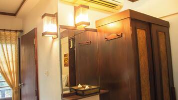 A bathroom with a wooden vanity, a mirror, and a towel rack.