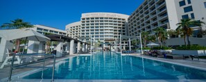 A hotel with a swimming pool, multiple floors, and palm trees. - Crowne Plaza Abu Dhabi Yas Island by IHG (Abu Dhabi)