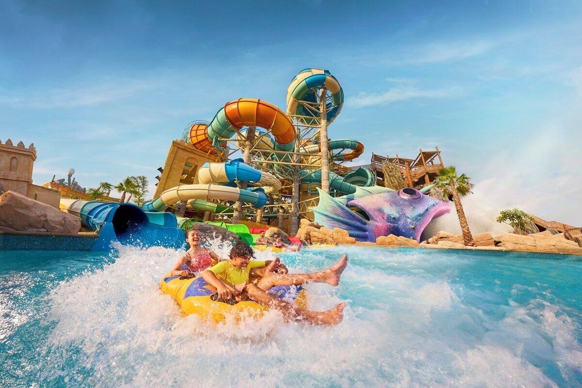 A water park with multiple water slides and a pool area.