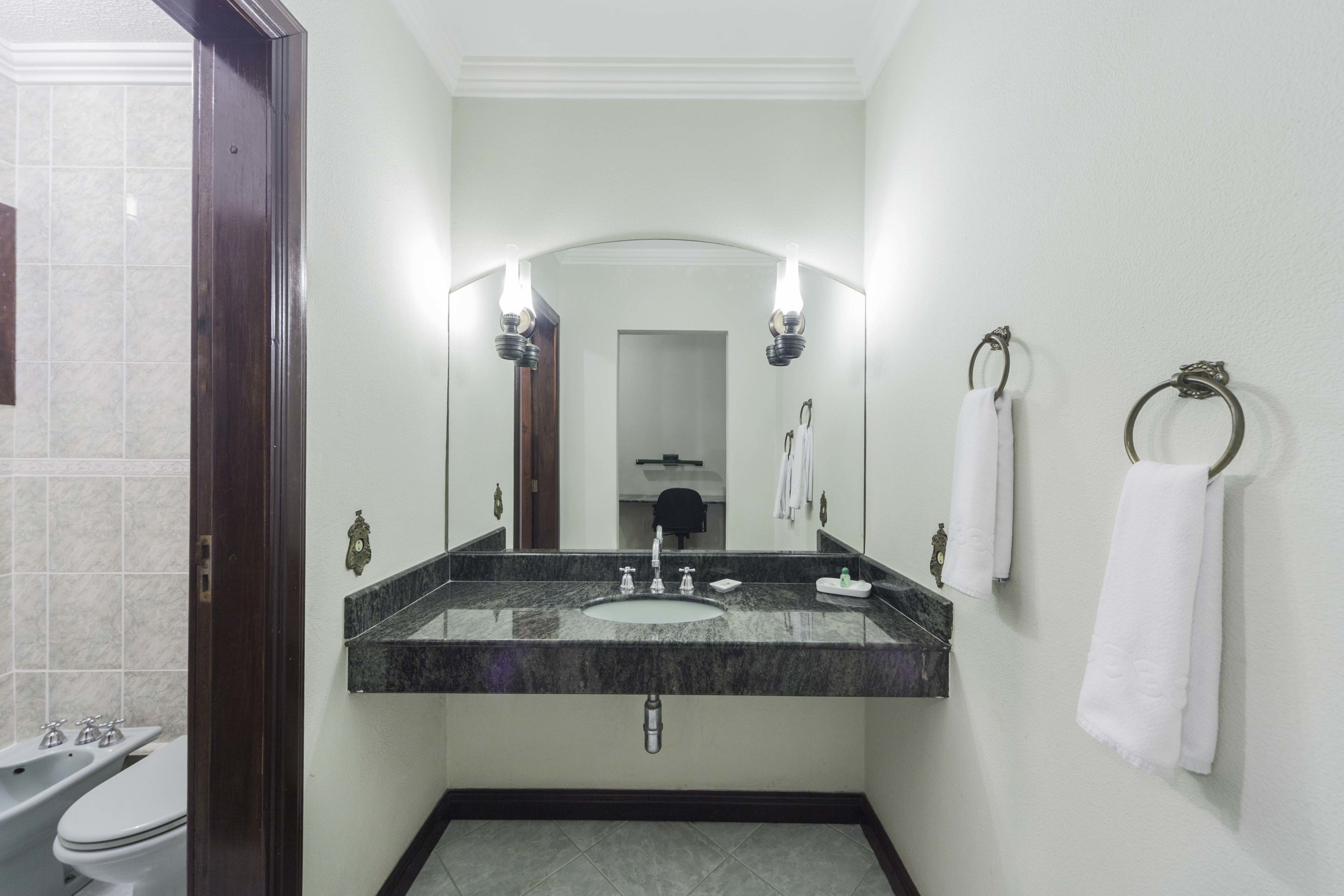 deluxe double room, 1 king bed | bathroom | shower, bidet, towels