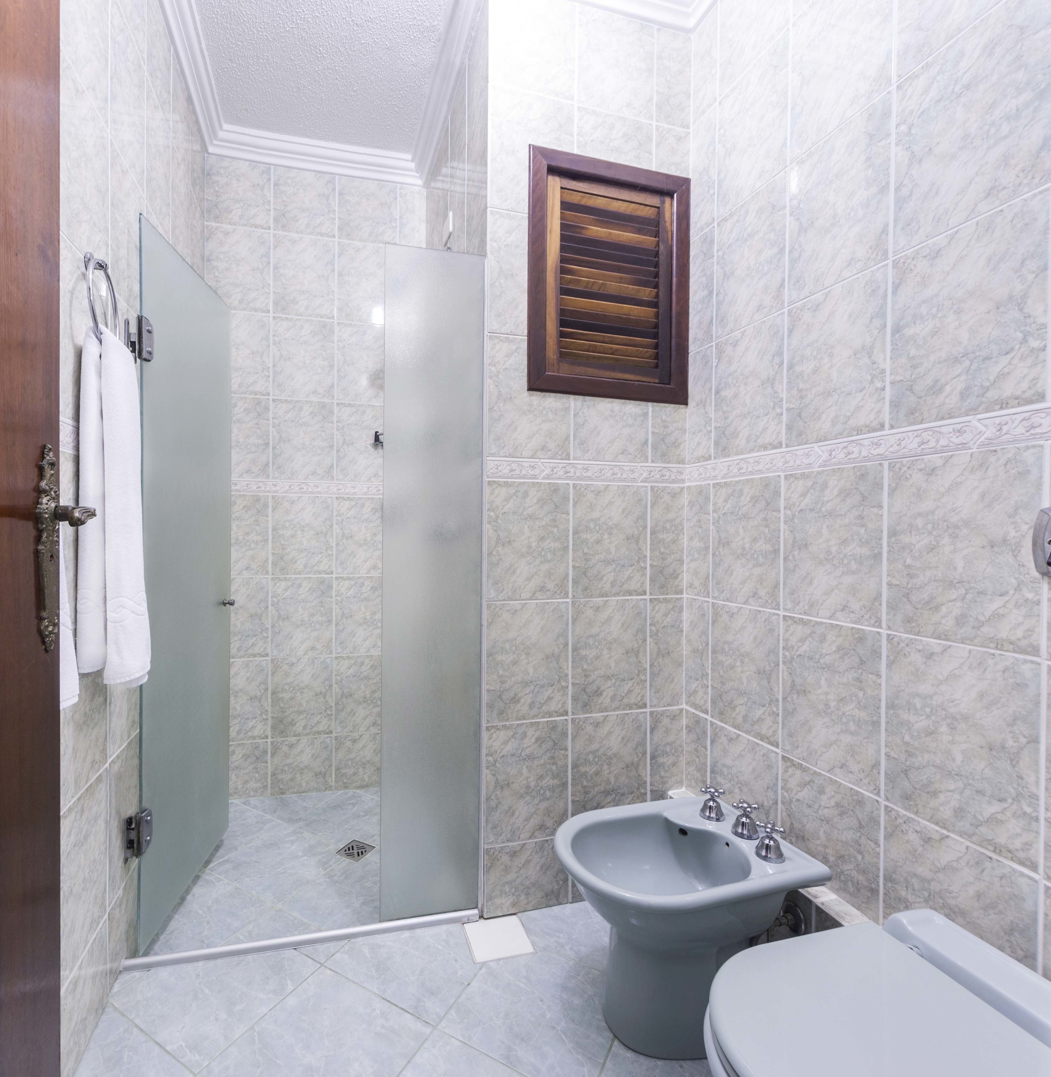 deluxe double room, 1 king bed | bathroom | shower, bidet, towels