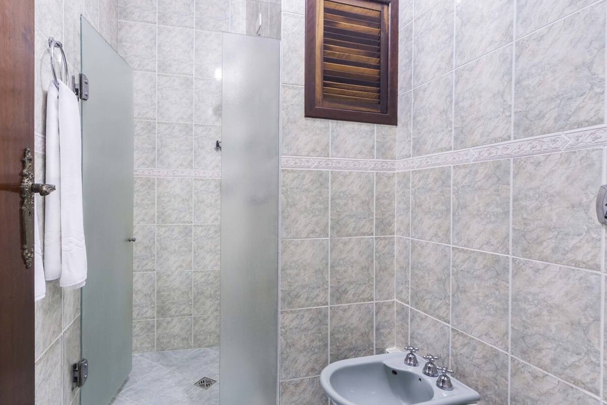 deluxe double room, 1 king bed | bathroom | shower, bidet, towels