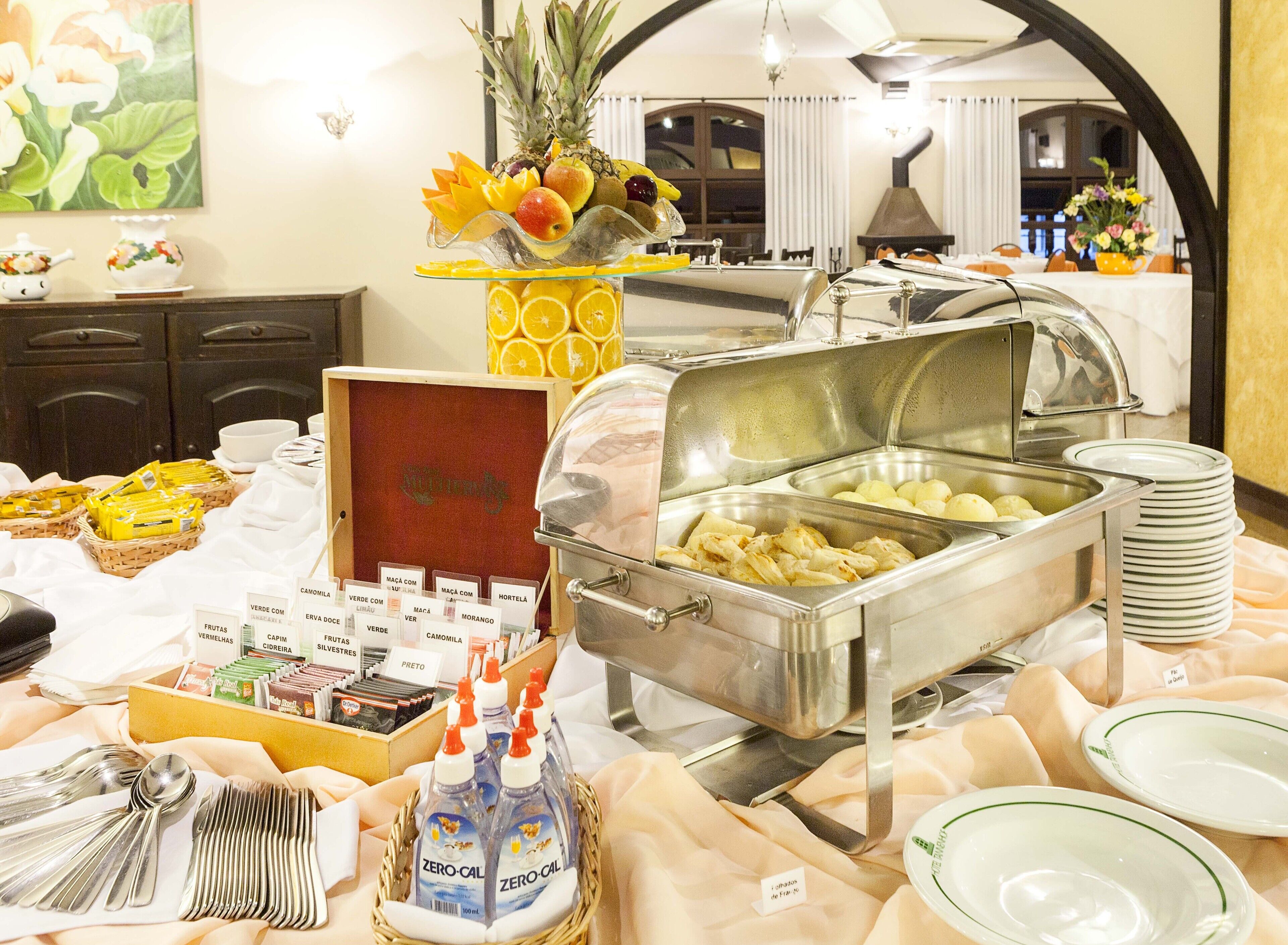 A buffet setup with various food items, including fruits and a buffet station with multiple dishes.