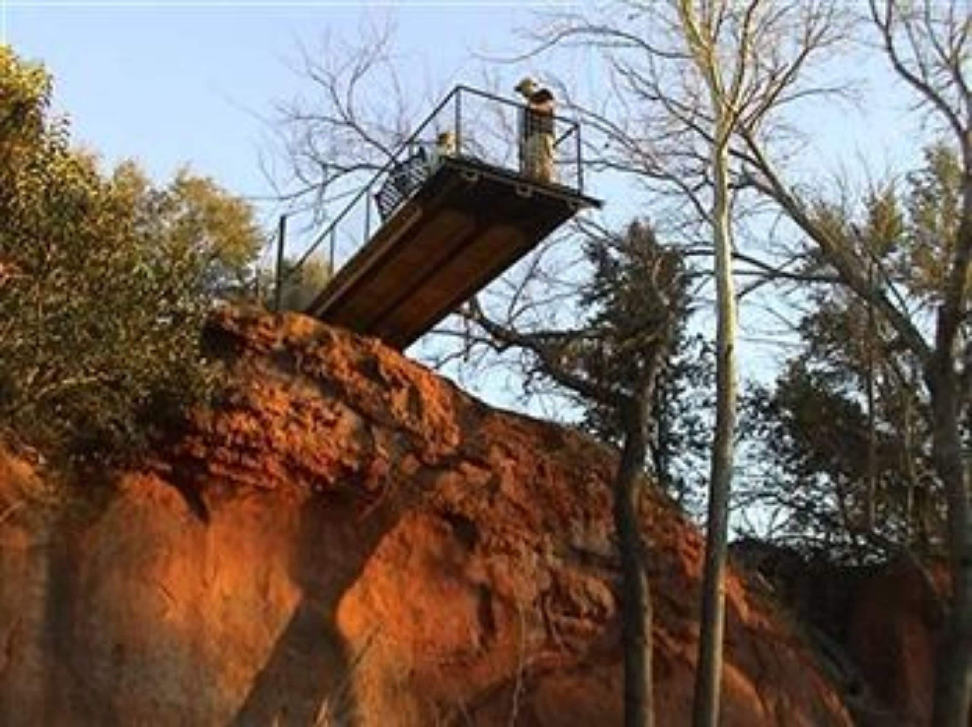 A rock formation with a metal viewing platform.