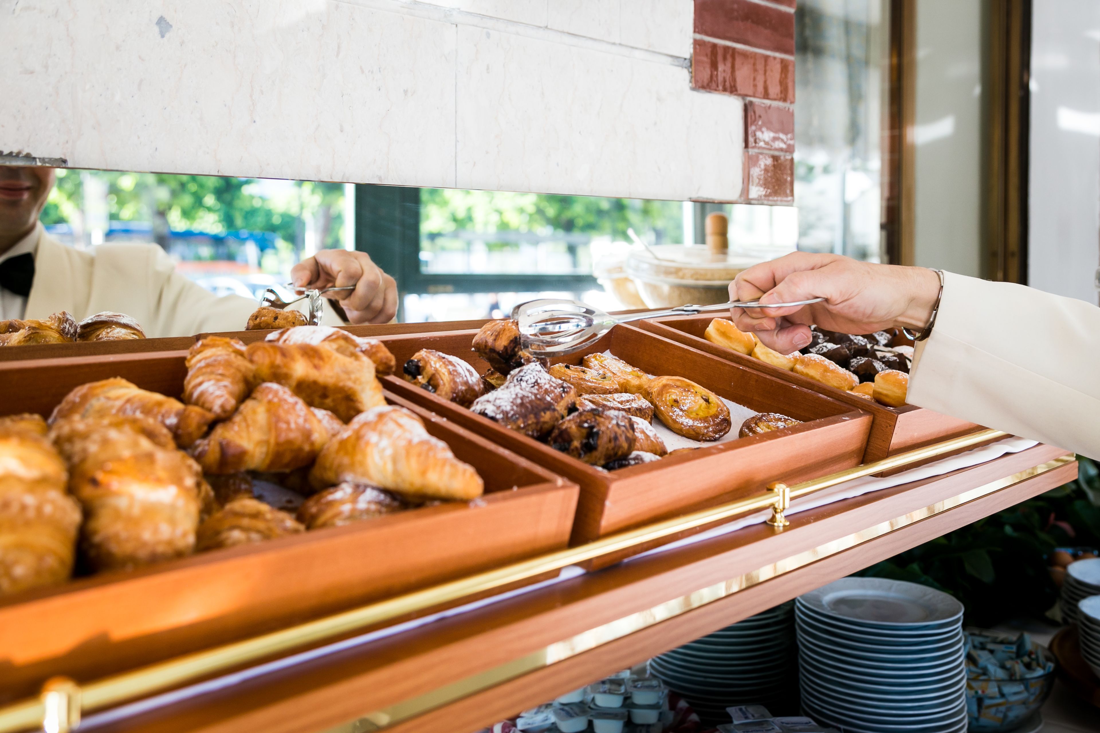 A buffet with various pastries and baked goods.