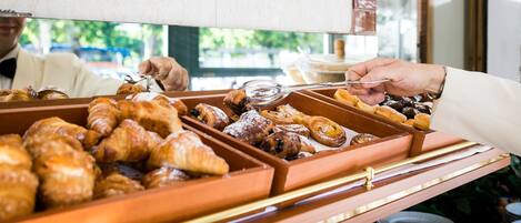 A buffet with various pastries and baked goods.