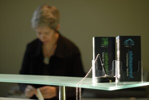 Two elegant boxes sit atop a table, accompanied by a writing instrument.