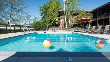Seasonal outdoor pool, open 10:00 AM to 10:00 PM, pool umbrellas