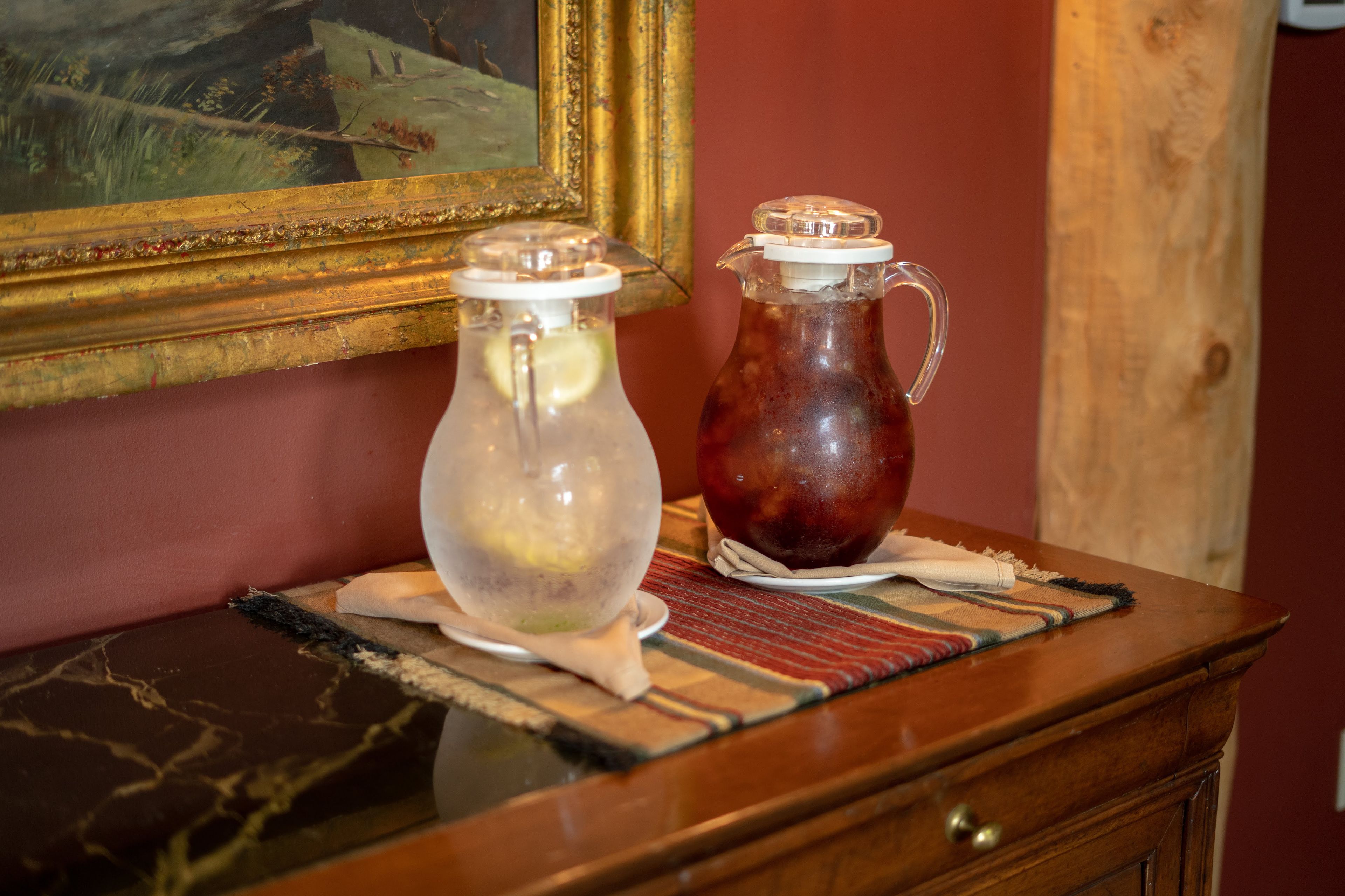Two glass containers on a wooden table with a patterned placemat.