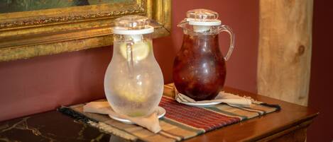 Two glass containers on a wooden table with a patterned placemat.
