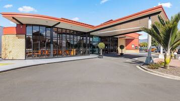 Enjoy outdoor dining and socializing in a pleasant setting with a covered walkway leading to the main entrance.