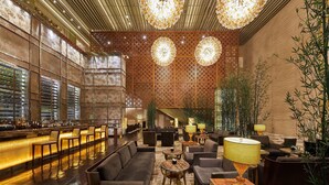 A spacious lobby with a bar area, seating arrangements, and decorative lighting fixtures. - The Westin Tianjin (Tianjin)