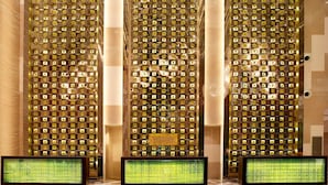 A lobby with a decorative wall featuring a pattern of square lights and a sign that reads "WESTIN". - The Westin Tianjin (Tianjin)