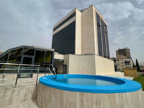 Seasonal outdoor pool, open 10:30 AM to 8:30 PM, pool loungers