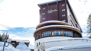 A multi-story hotel with a curved facade and a prominent 'Belambra hotels' sign.