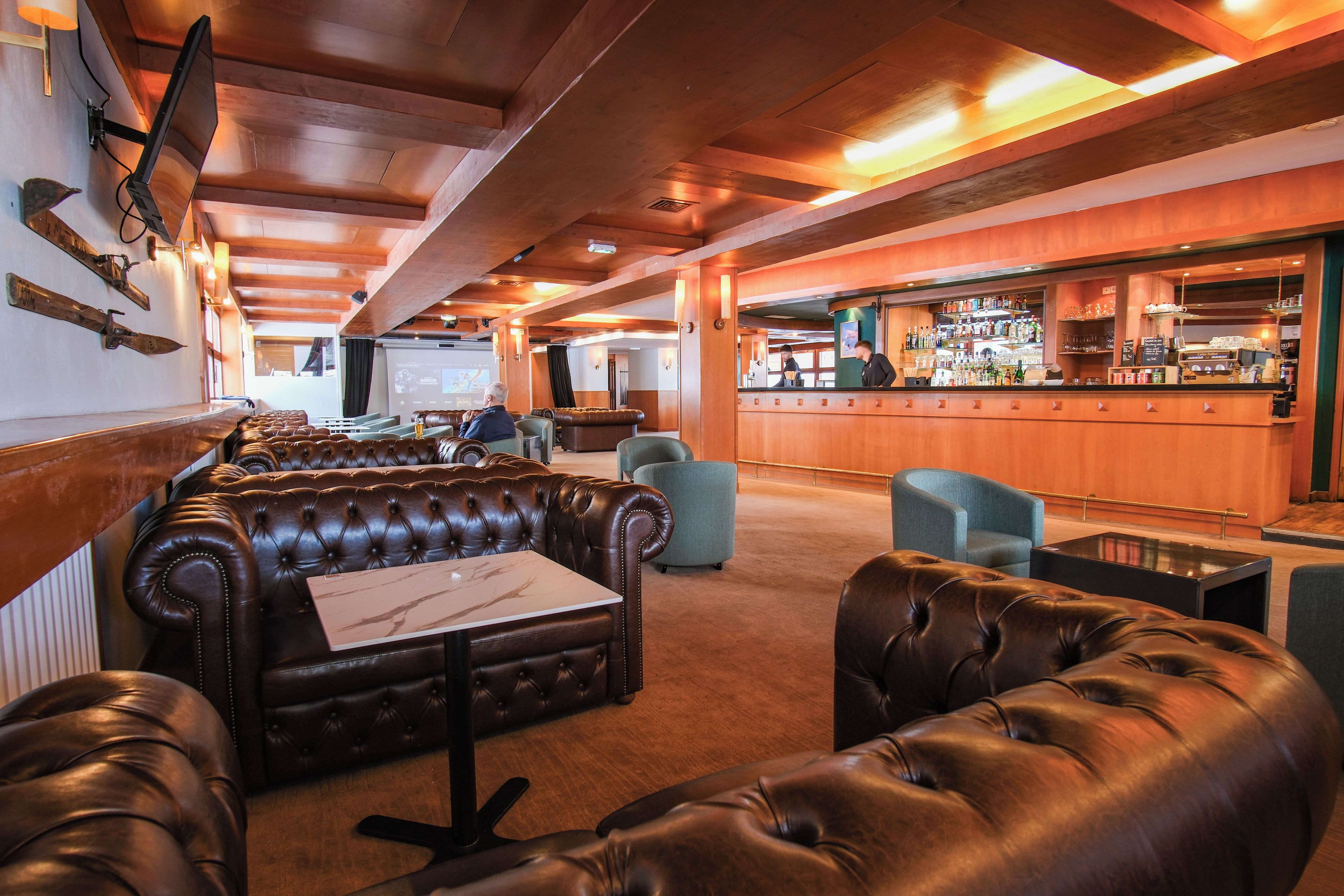 A bar area with a counter and seating.