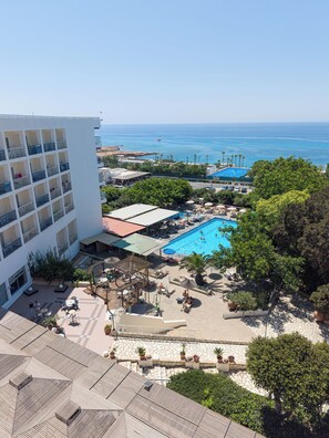 A hotel with a pool, outdoor seating, and a view of the sea. - Marina (Ayia Napa)