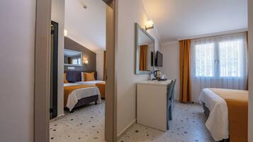 A hotel room with two beds, a desk, a mirror, a television, and a window with curtains.
