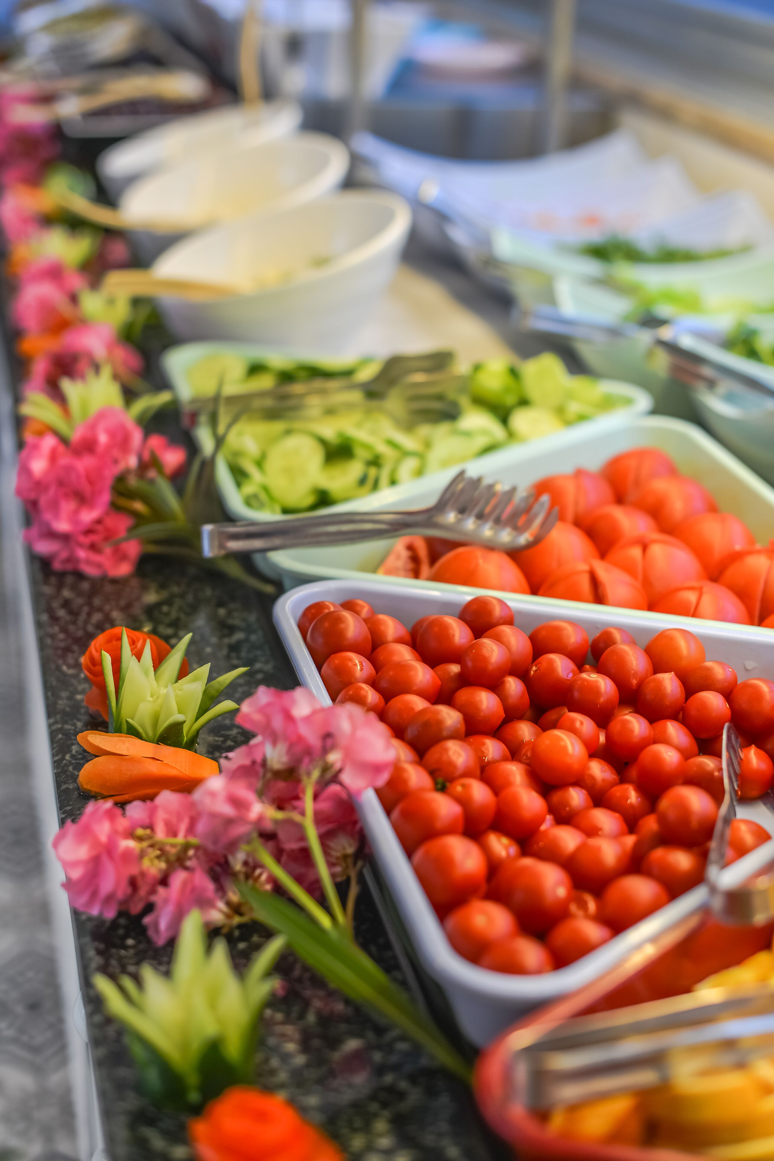 A buffet with various food items and utensils.