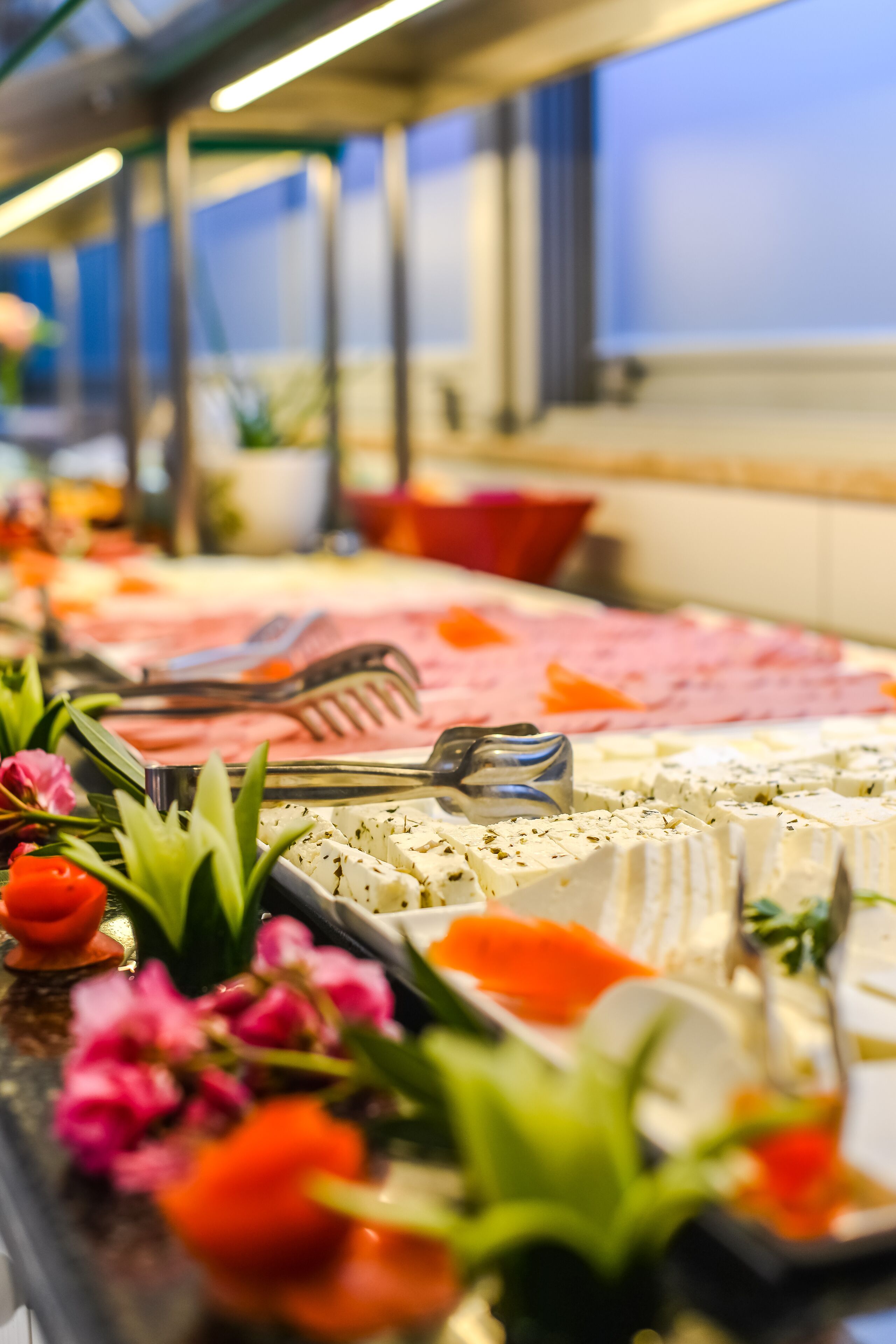A buffet with various food items and utensils.