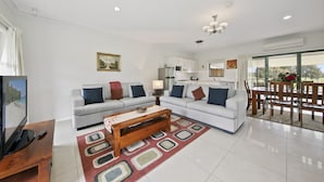 A modern living room with a sofa set, a coffee table, and a TV. - Talga Estate (Lovedale)