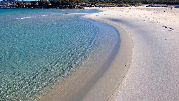A wide, sandy beach with clear turquoise water and a gentle curve. - Hotel Rocce Sarde (Olbia)
