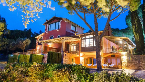A two-story house with a balcony, stone walls, and a well-lit exterior. - Mas Ses Vinyes - Adults Only (Begur)