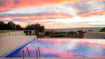 Seasonal outdoor pool, open 9:30 AM to 8:00 PM, pool umbrellas