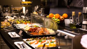 A buffet with various food items and condiments.
